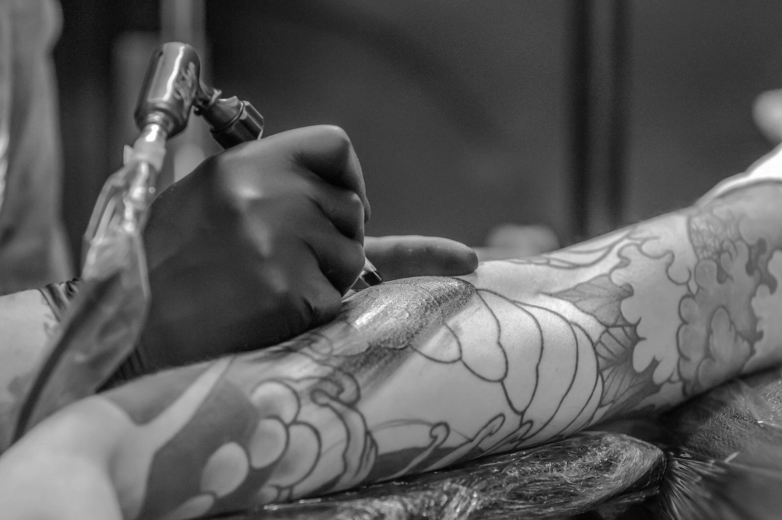 a person getting a tattoo on their hand