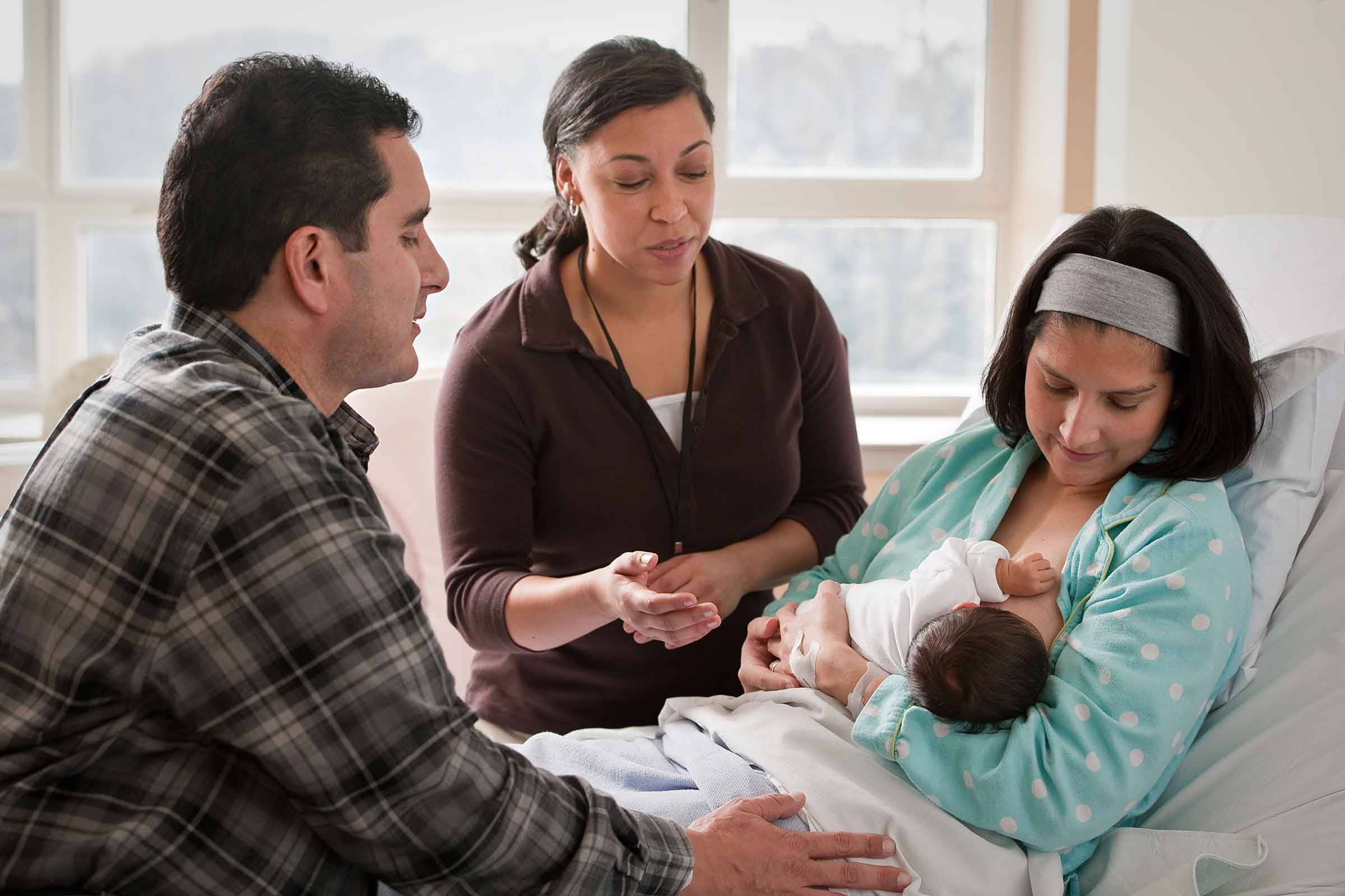 a counselor teaching mother about proper breastfeeding latch and techniques for good feed