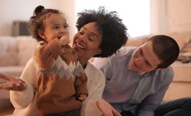 Photo of young kids with adults playing with toys